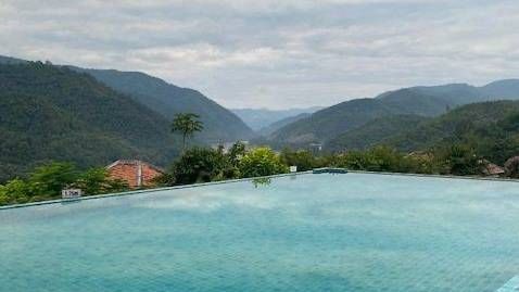 Mountain view infinity pool at scenic resort in northern Thailand
