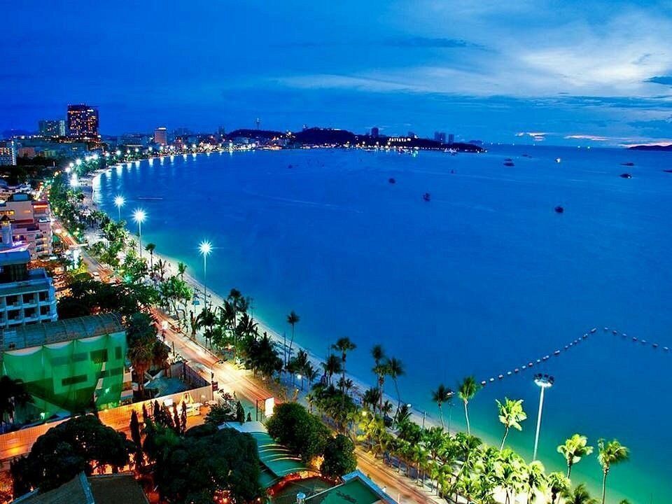 Aerial night view of Pattaya Beach coastline illuminated along the Gulf of Thailand