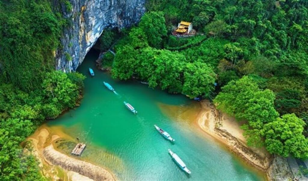 Boats entering limestone caves at Phong Nha-Ke Bang National Park in Vietnam
