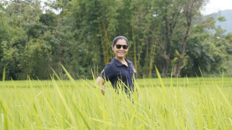 Smiling motorcycle tour rider posing with adventure bike in Northern Thailand