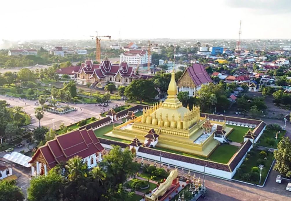 Aerial view of Vientiane city with the golden That Luang stupa in Laos