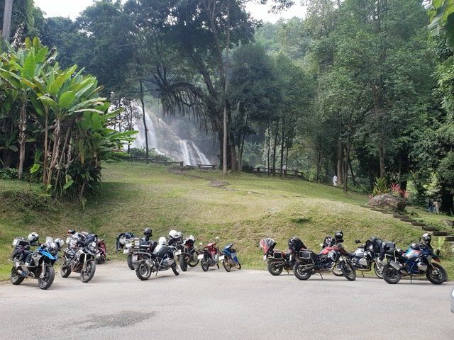 Motorbike group stop at Wachirathan Waterfall in Doi Inthanon National Park Thailand