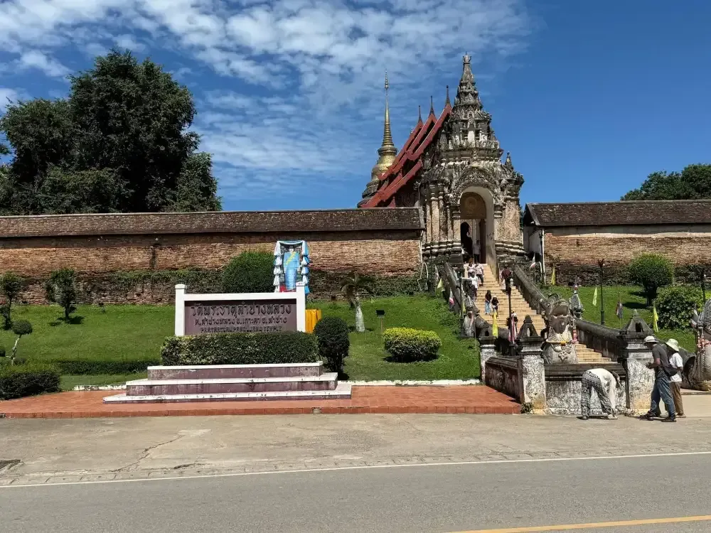 Ancient brick walls and grand entrance of Wat Phra That Lampang Luang temple in Lampang, northern Thailand