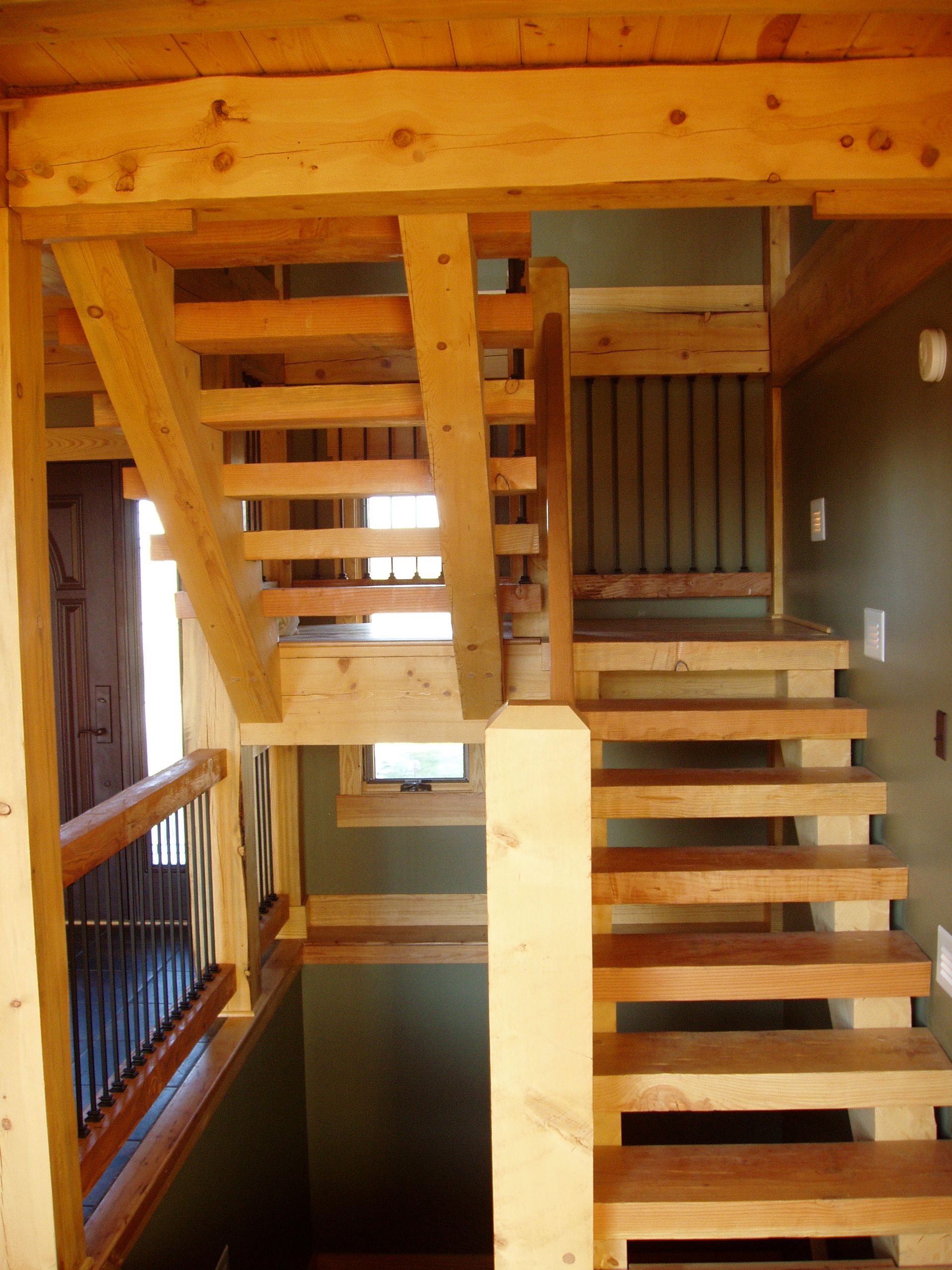 Bottom of Wooden Stairs. Design Built Homes Is Columbia, MO's Top Timber Home Builder. 