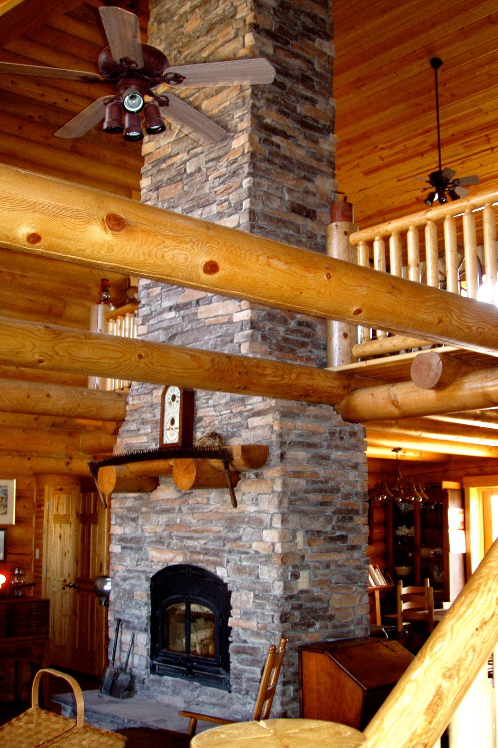 Log Framework & Stone Fireplace in a Mid-Missouri Home By Dream Built Homes.