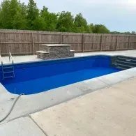 inground pool with water feature