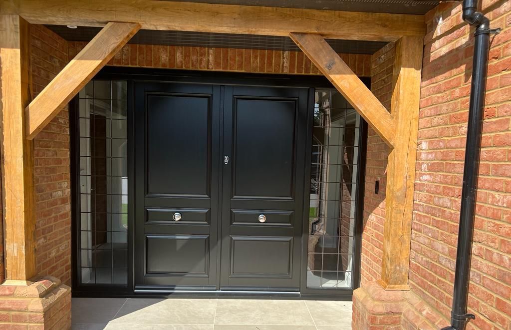 A black engineered timber door installed by Aspen Home Improvement