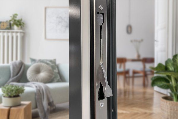 A close up of a door lock in a living room.