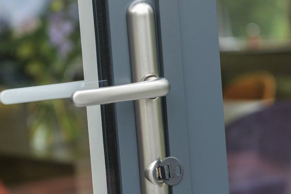 A close up of a door handle on a sliding glass door.