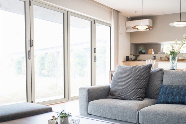 A living room with a couch , table , and sliding glass doors.