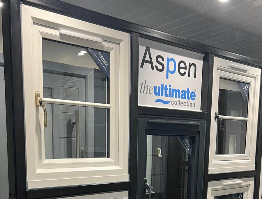 Display of Aspen Ultimate Collection windows in a showroom; black and white frames.