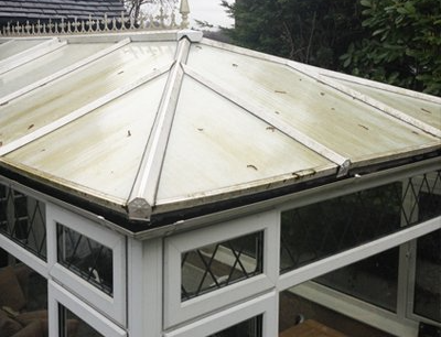 A conservatory with a roof that is dirty and needs to be cleaned.