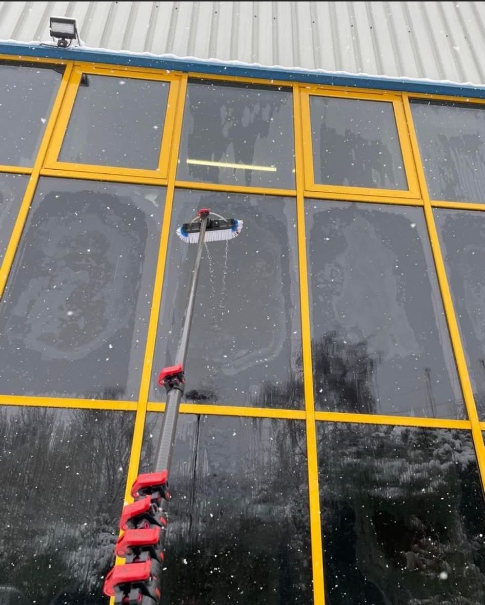 a person is cleaning the windows of a building