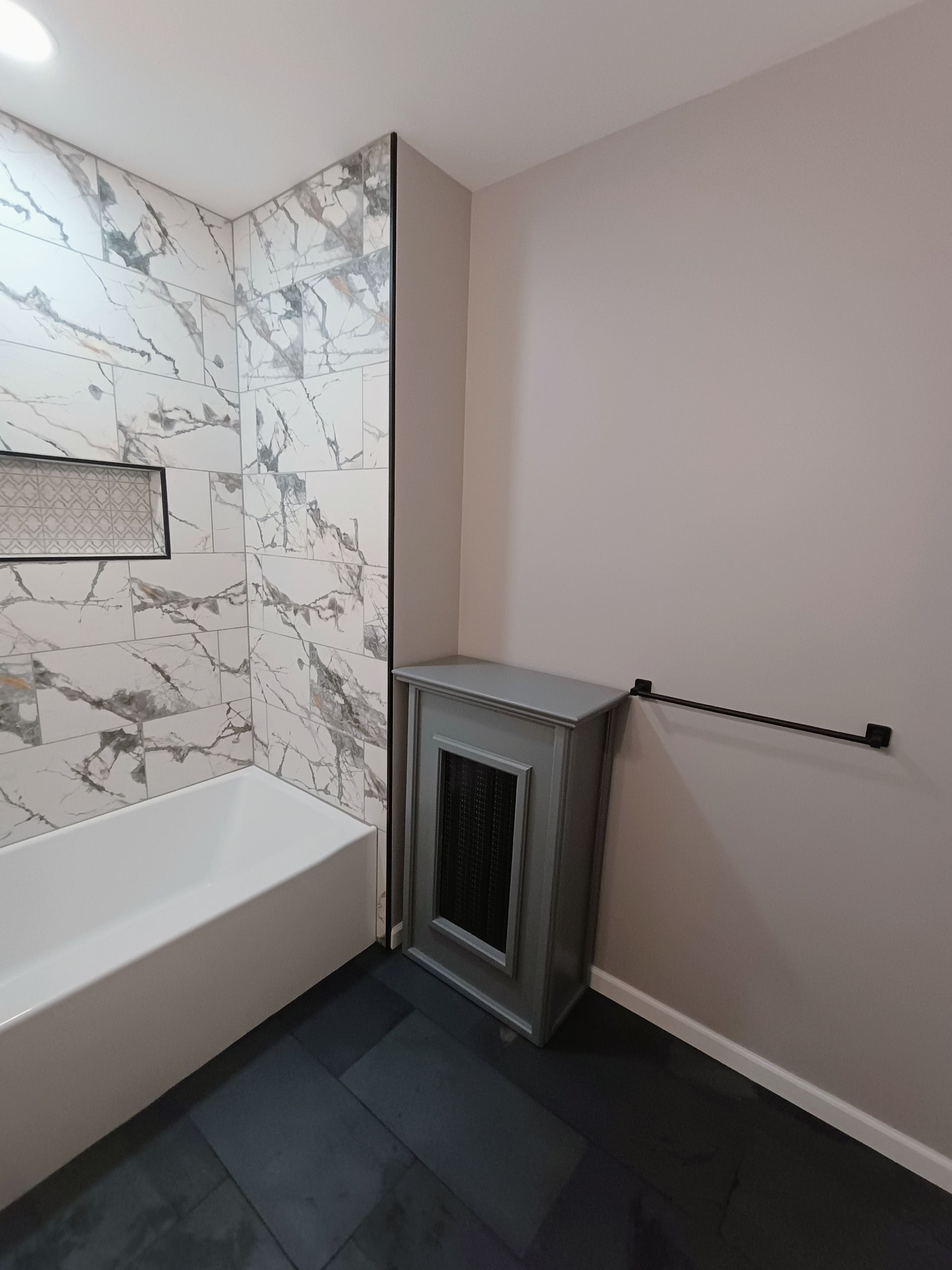 A bathroom with a bathtub and a fireplace