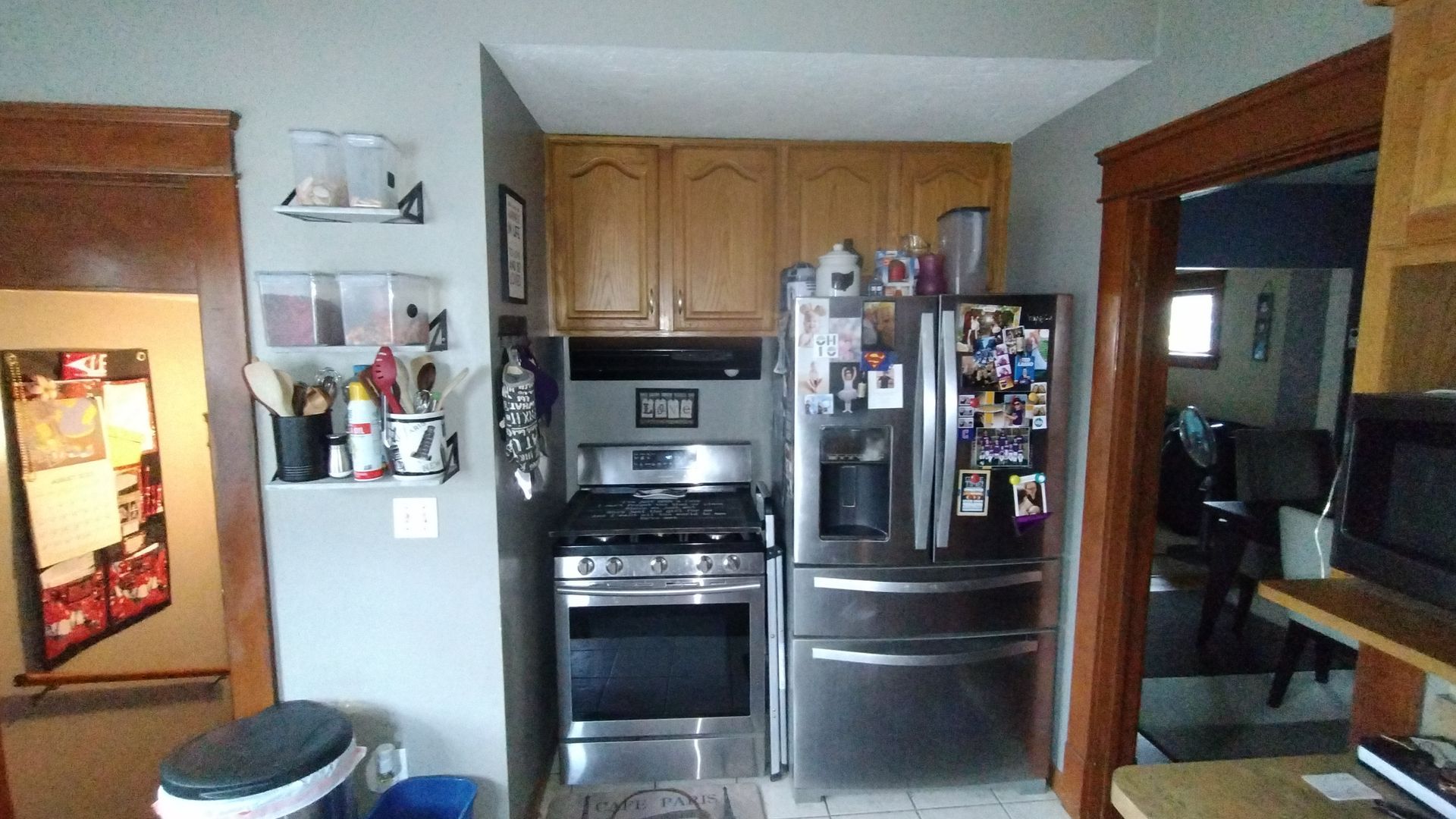 A kitchen with a stove , refrigerator , and microwave