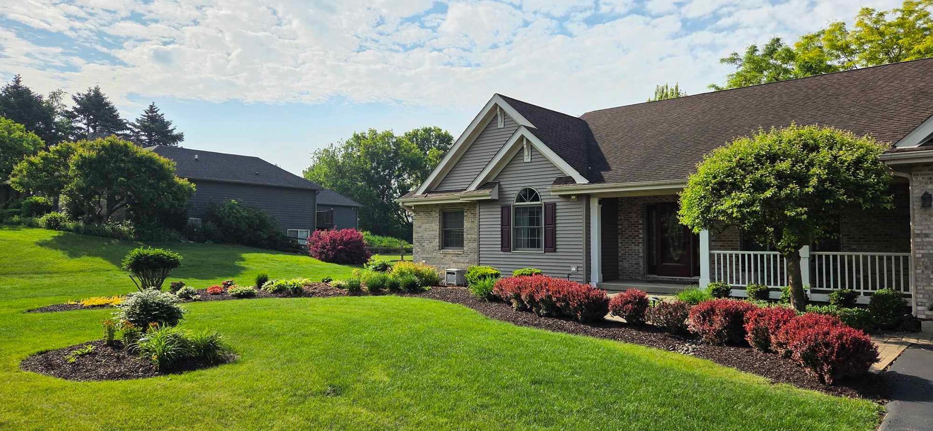 A large house with a lush green lawn in front of it.