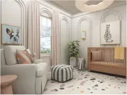 A bright nursery featuring a light-colored armchair, a crib, a geometric ottoman, and wall art in a neutrally toned room.