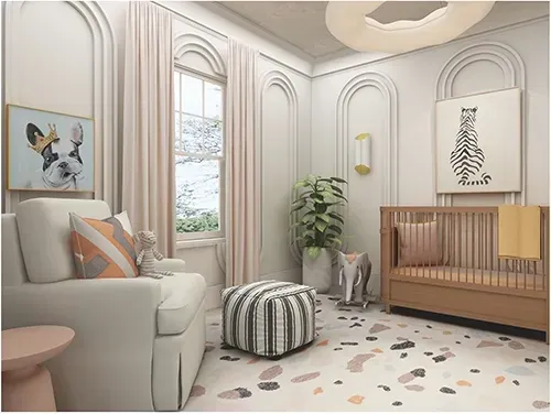 A bright nursery featuring a light-colored armchair, a crib, a geometric ottoman, and wall art in a neutrally toned room.
