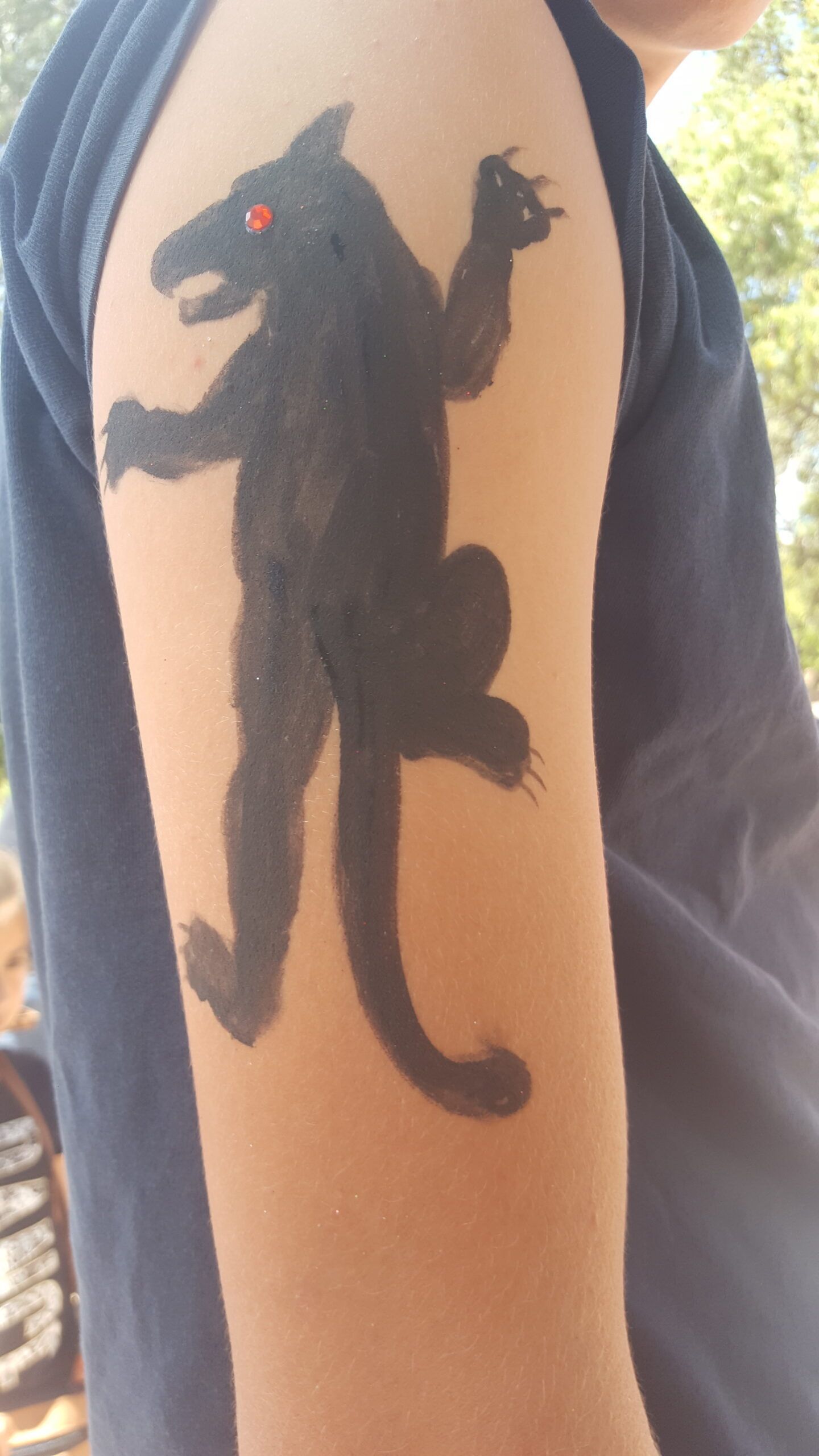 A person has a black panther tattoo on their arm