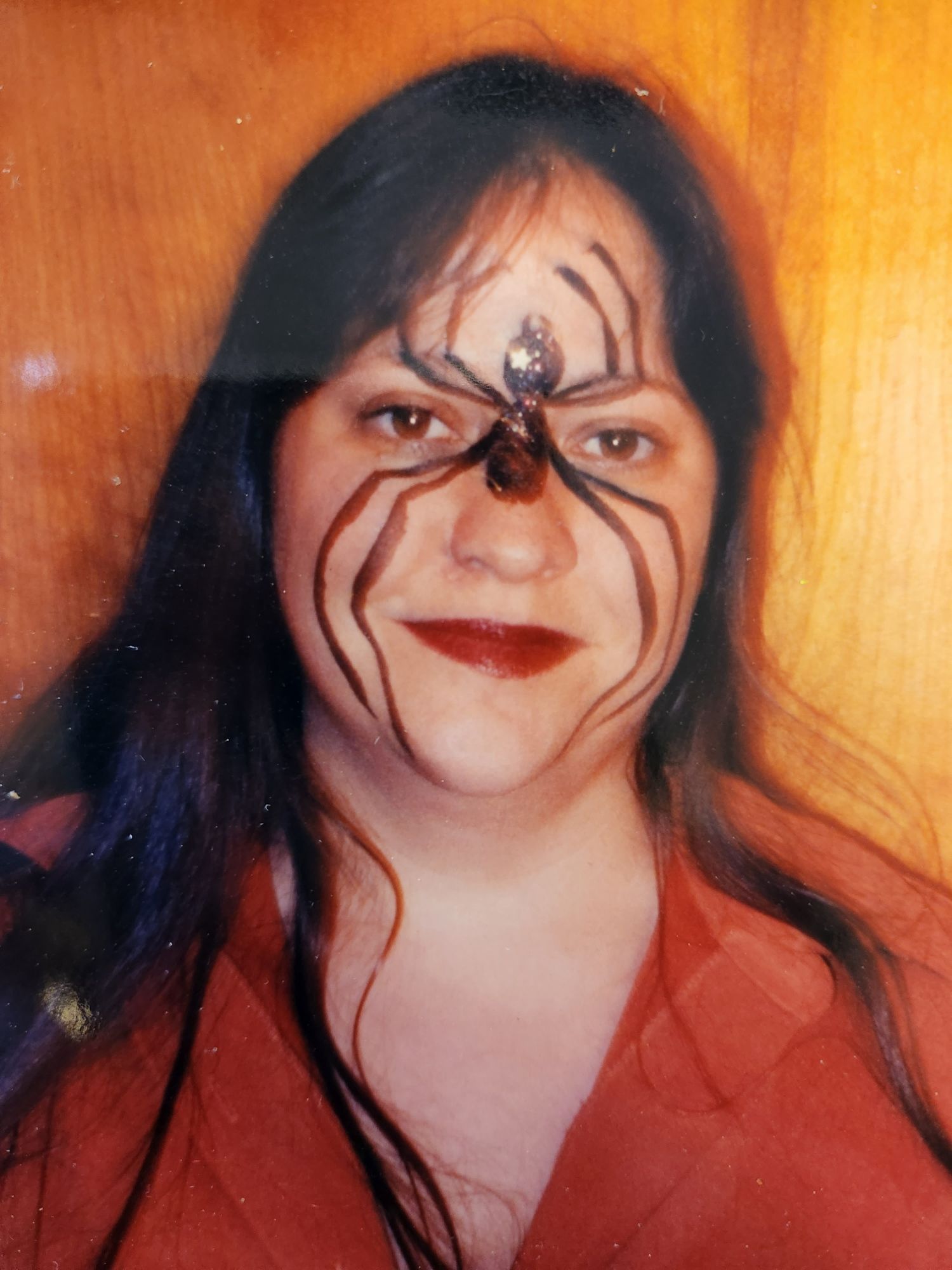 A woman with a spider painted on her face