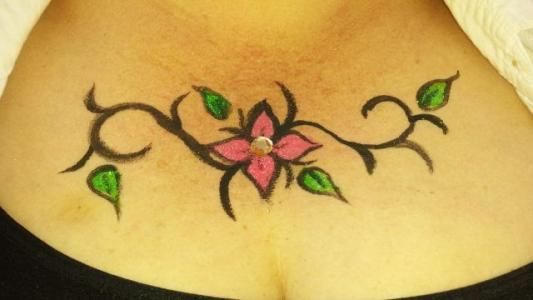 A woman has a flower tattoo on her chest