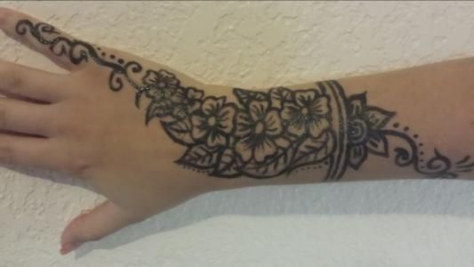 A close up of a person 's hand with a tattoo on it