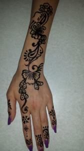 A woman 's hand with a henna tattoo on it