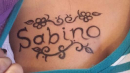 A person has the name sabino written on their chest