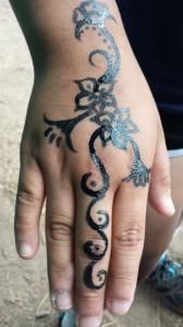 A close up of a person 's hand with a tattoo on it.