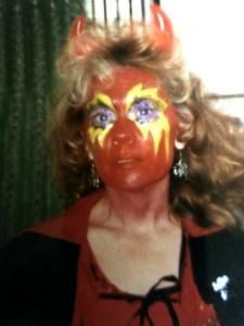 A woman with devil horns painted on her face
