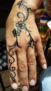 A close up of a person 's hand with a tattoo on it.