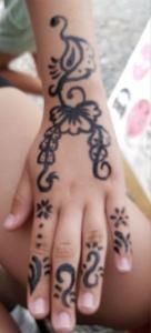 A close up of a person 's hand with a tattoo on it