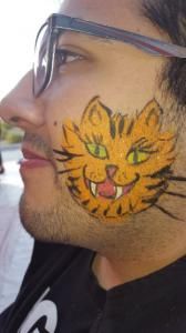 A man with a cat painted on his face.