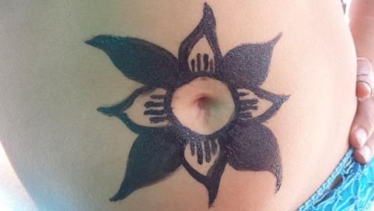 A woman has a flower tattoo on her belly