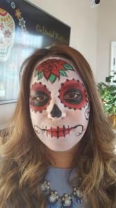 A woman with her face painted like a sugar skull.