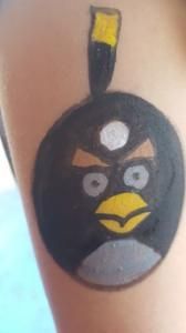 A person has an angry bird painted on their arm