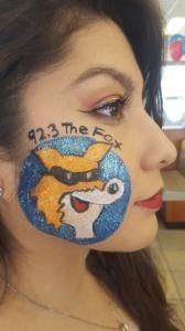 A woman has a picture of a fox painted on her face