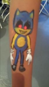 A child has a drawing of sonic the hedgehog painted on their leg