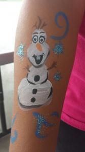 A person has a snowman painted on their arm.