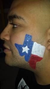 A man has a texas flag painted on his face.