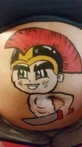 A pregnant woman has a cartoon drawing of a spartan on her belly.