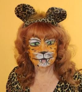 A woman with her face painted to look like a leopard