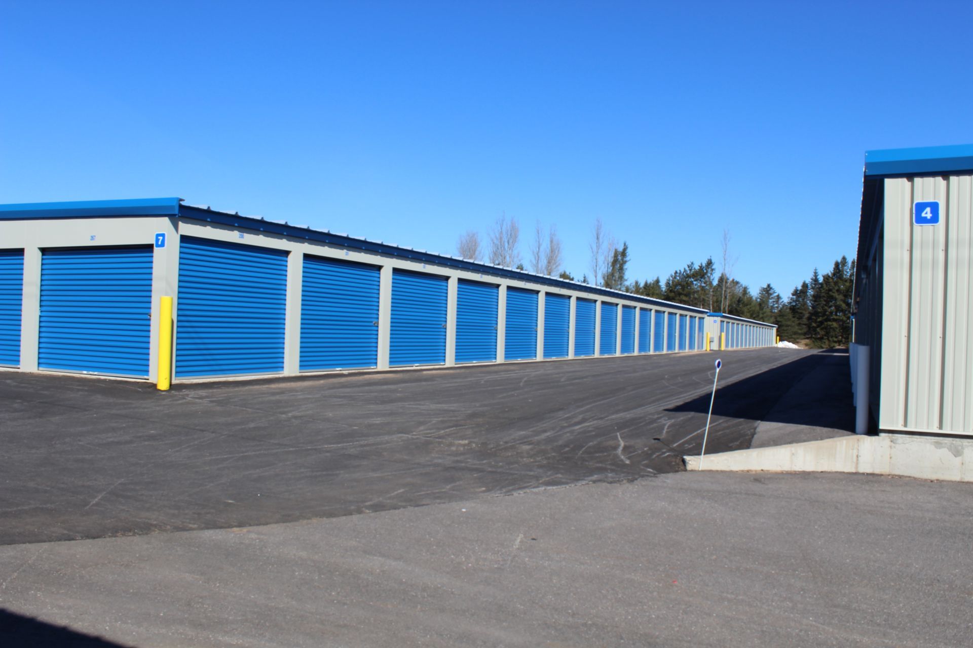 A row of blue garage doors with the number 5 on them