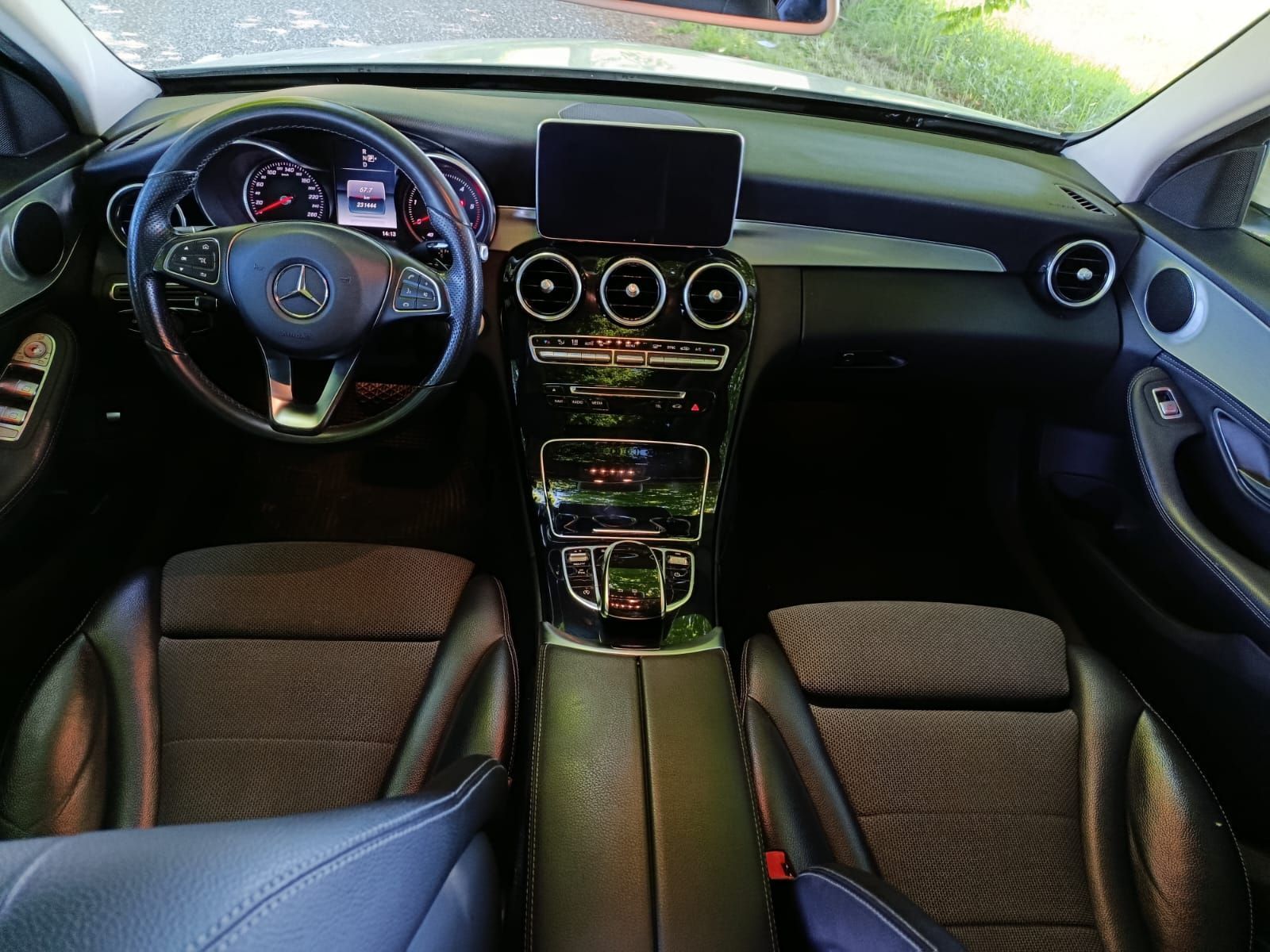 Interni di lusso con cruscotto nero, tre bocchette di ventilazione centrali e volante con finiture blu.