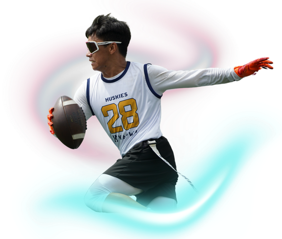 A flag football player wearing a white jersey with the number 28, black shorts, and sunglasses, running with a football.