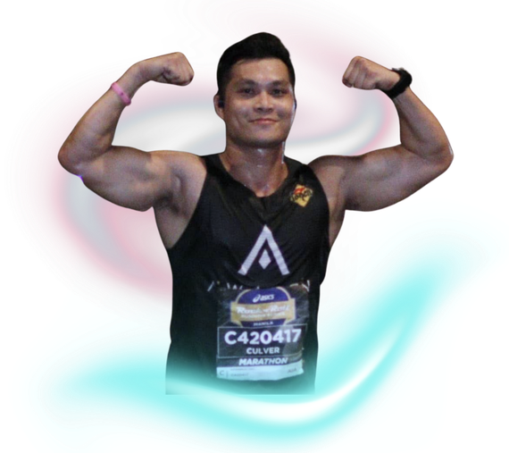 A muscular person wearing a black marathon tank top with race bib C420417, flexing both arms with a smile.