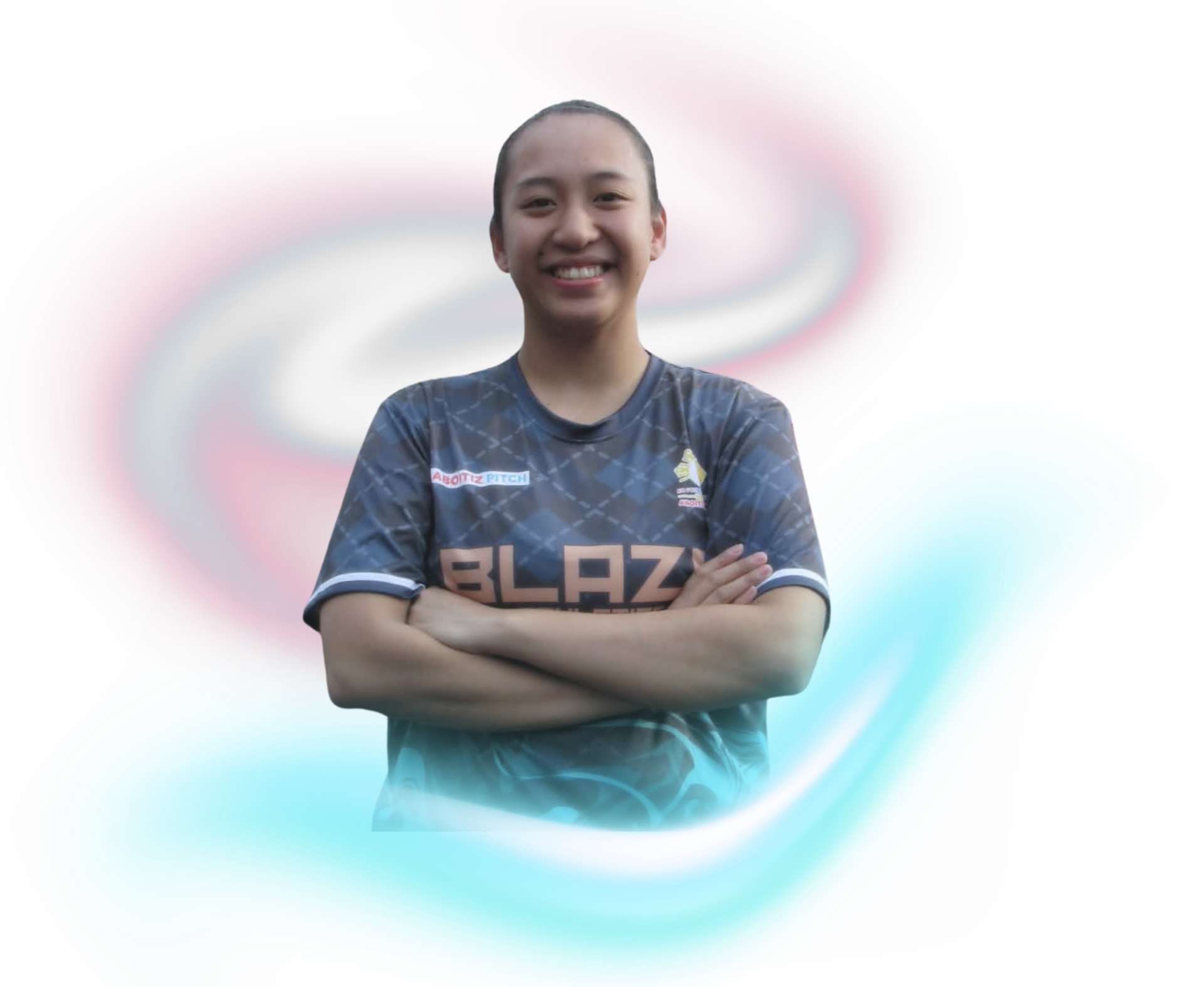 A person with long, dark, curly hair wearing a gray t-shirt, posed against a background of soft, glowing light swirls.