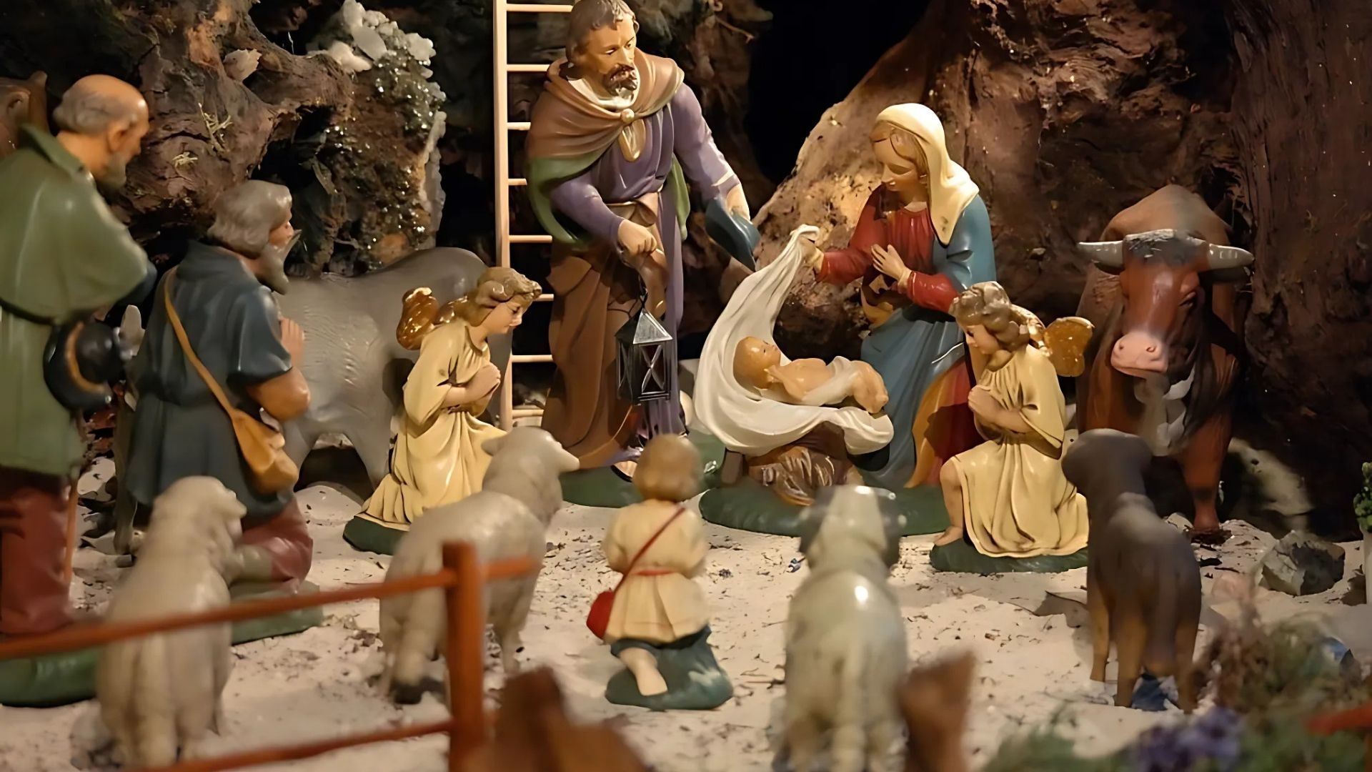 Nativity scene with figures, including Mary, Joseph, baby Jesus, angels, animals, and shepherds.