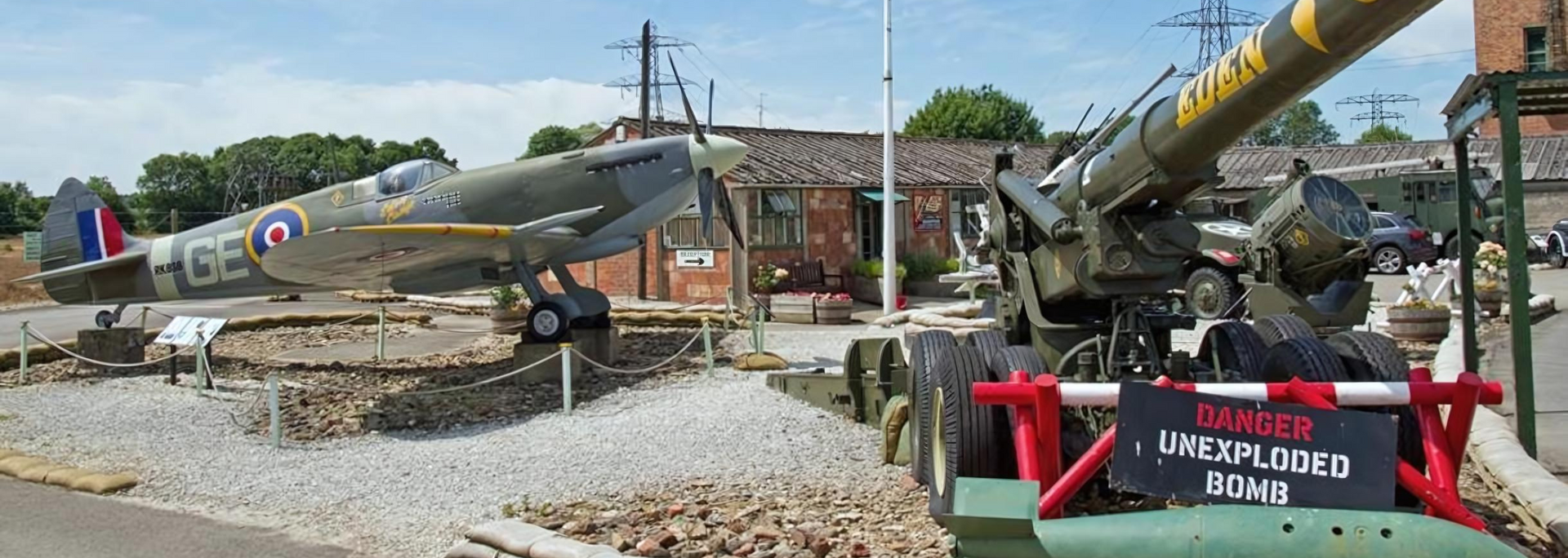 A war plane and cannon display in a museum with a sign reading 