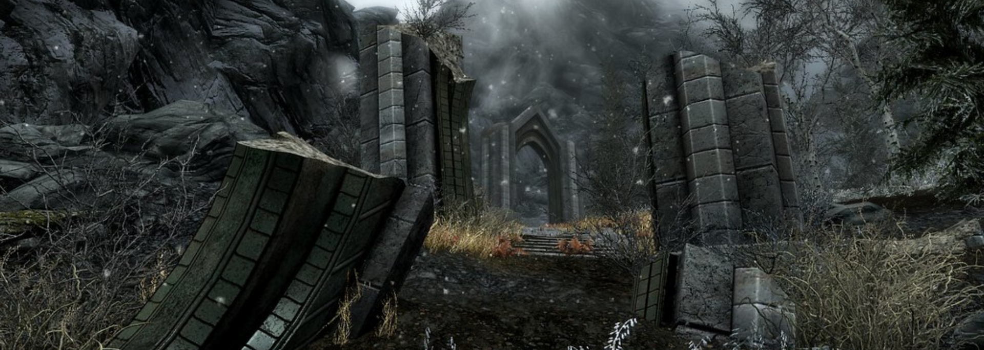 Ruined stone structure in a snowy, mountainous landscape. Arched entrance visible in the distance.